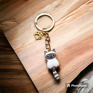 Cat charm.  White & grey cat with stripped tail.